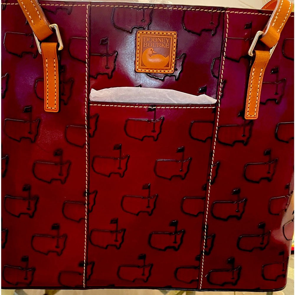 Dooney & Bourke handbag with Master’s emblem.  11 1/2” by 14”.